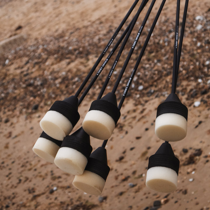 set of black and white foam headed arrows for larp and cosplay being held on the beach