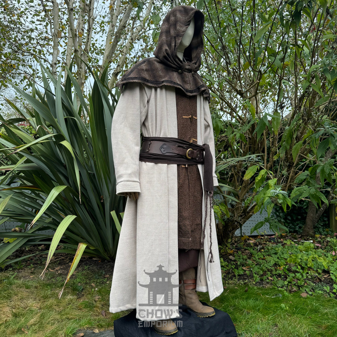 Medieval LARP costume side view, featuring a light brown full length robe, snood hood, and sash. For Renaissance Faire and historical roleplay events.