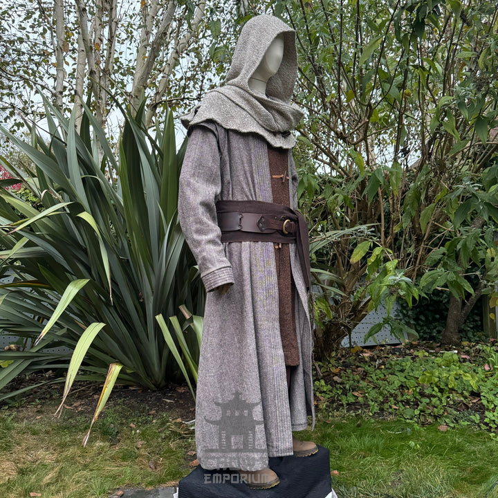 Medieval LARP costume side view, featuring a brown full length robe, two-tone jacket, hood, trousers, belt and sash. For Renaissance Faire and historical roleplay events.