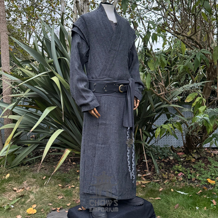 Medieval LARP costume side view, featuring a grey full length robe, black leather belt and grey sash. For Renaissance Faire and historical roleplay events.