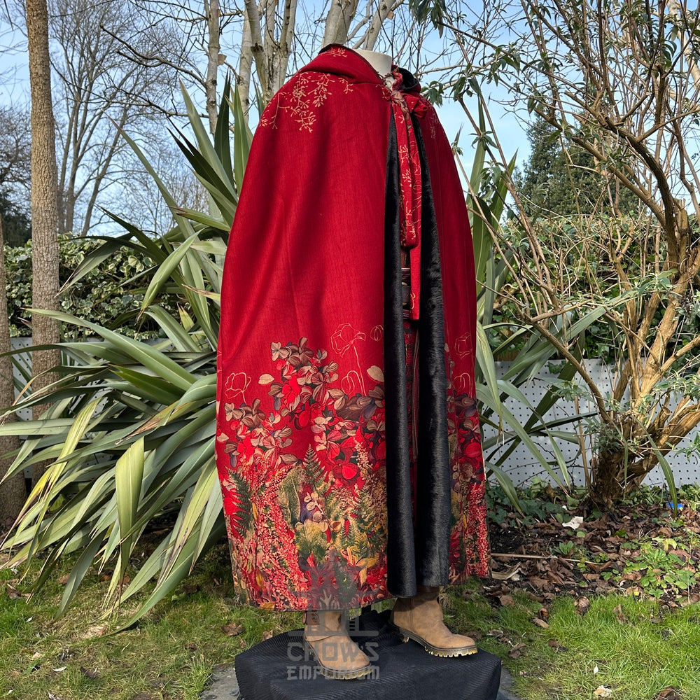 Red embroidered LARP cloak with fur lining, medieval fantasy cosplay costume for Renaissance Faires and events. Hood down, side view.