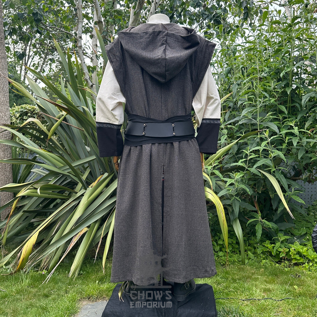 Medieval LARP costume back view featuring brown sleeveless robe, tunic, trousers, and sash. For Renaissance Faire and historical roleplay events.