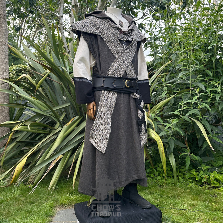 Medieval LARP costume side view featuring brown sleeveless robe, tunic, trousers, hood, belt and sash. For Renaissance Faire and historical roleplay events.