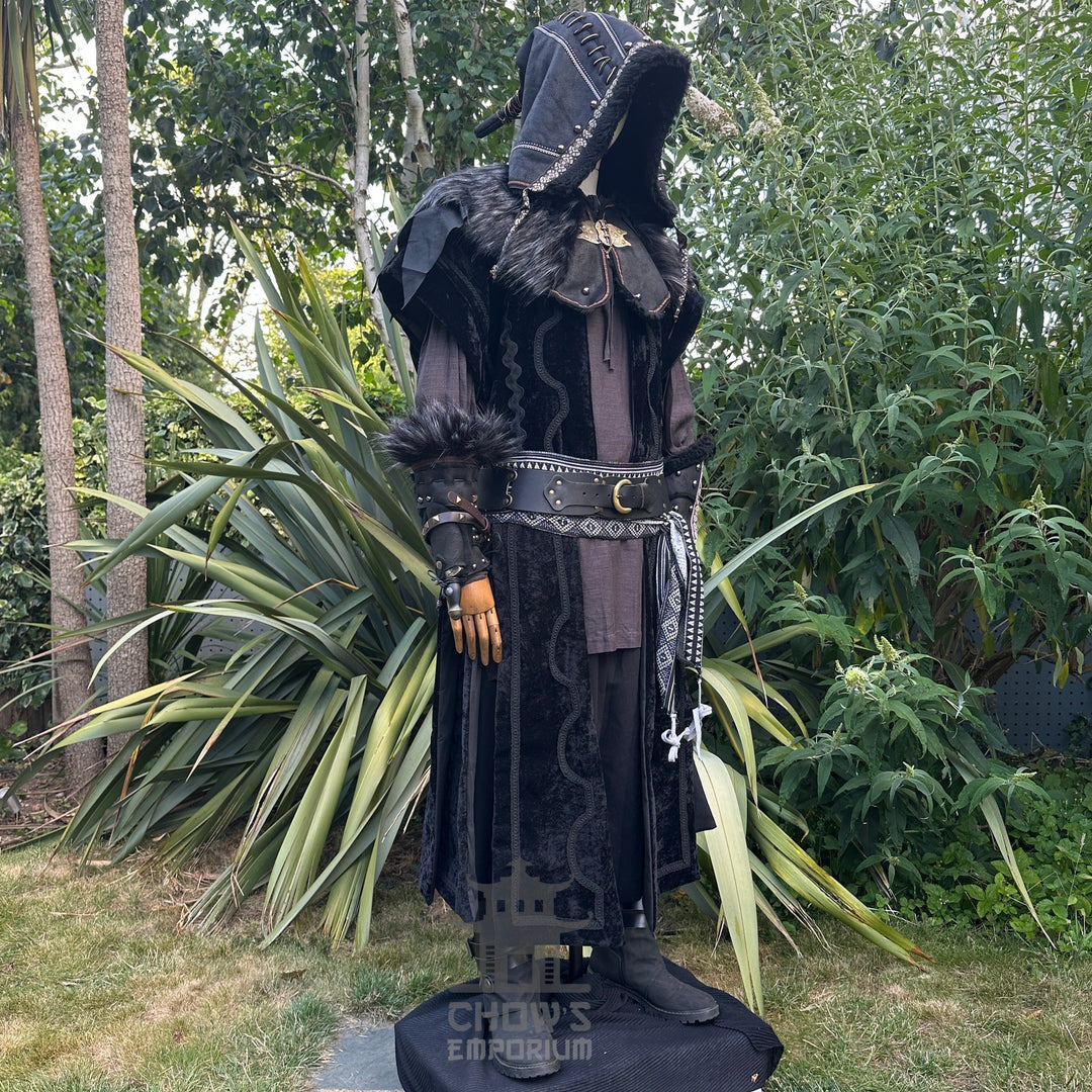 Medieval LARP costume side view featuring waistcoat, hood, vambraces, shirt, trousers, belt, and sash. For Renaissance Faire and historical roleplay events.