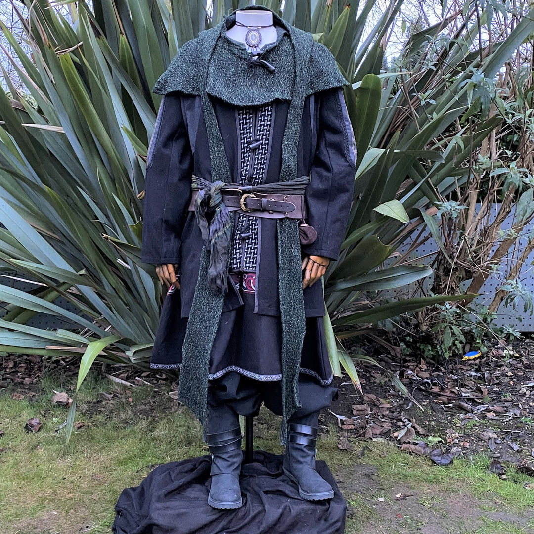 Medieval LARP costume front view, featuring a black and grey wool jacket with ornate panels, a two-tone linen tunic, and a sash. For Renaissance Faire and historical roleplay events.