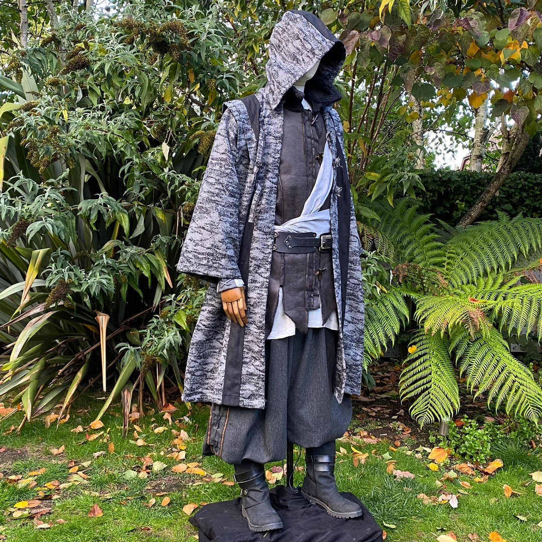 Medieval LARP costume side view, featuring grey and black hooded robe, and a grey woollen wraparound hood. For Ren Faire and historical roleplay events.