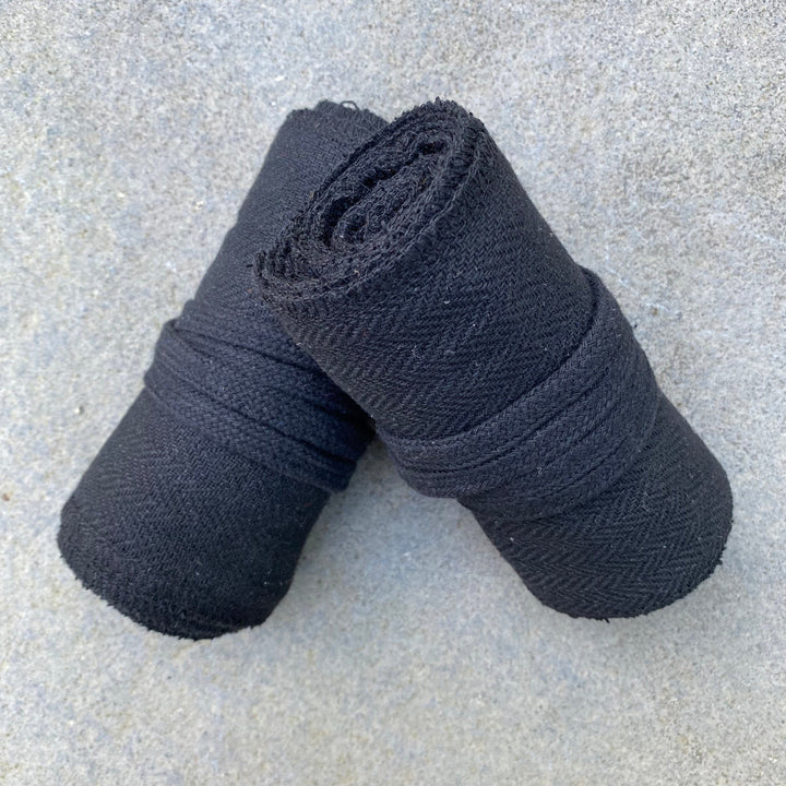 Set of Medieval LARPing Leg Wraps. They are Black and made out of a Herringbone Wool mixture which are used to keep Trouser flares out of the way and legs warm. These Viking Wraps can wrap around your Legs to provide an extra flare to LARP kit.