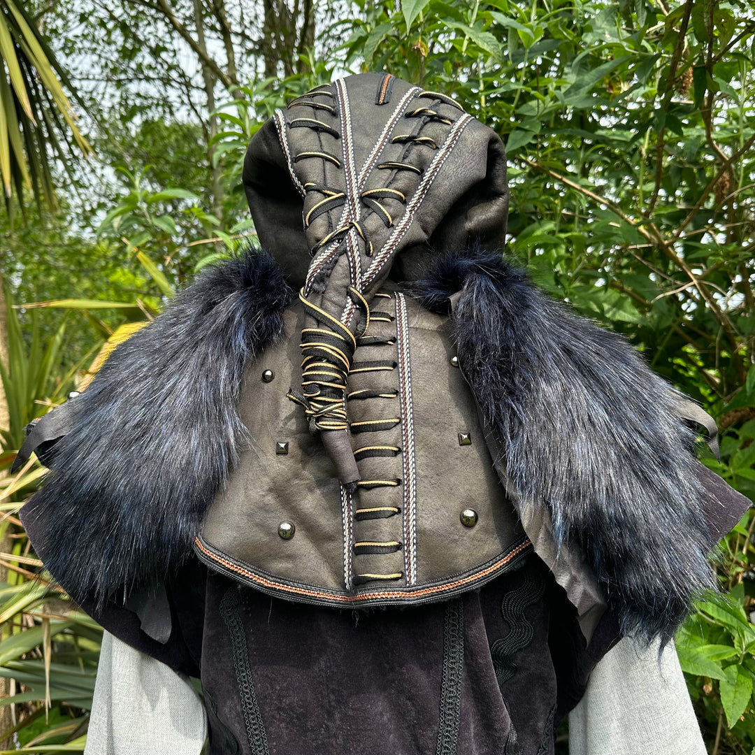 This Ornate LARP Hood in Black Faux Leather has a Faux Fur Mantle in Black & Blue. This Viking Hood is Water Resistant towards rain. The Medieval Hood covers your shoulders and provides warmth. This LARP Hood has metal Clasps, perfect for your LARP Character and LARP Costume, Cosplay Event, and Ren Faire.