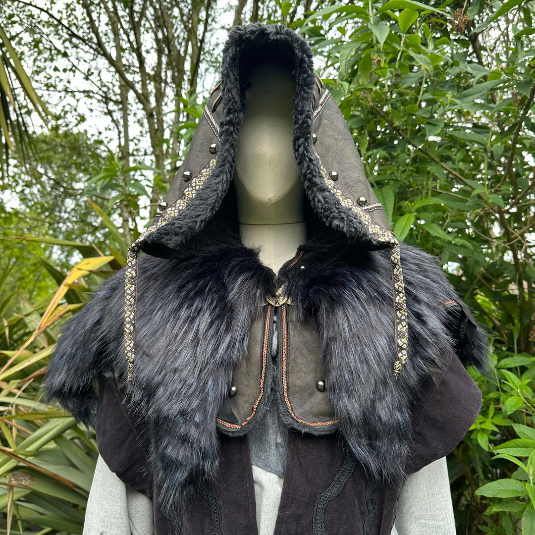 This Ornate LARP Hood in Black Faux Leather has a Faux Fur Mantle in Black & Blue. This Viking Hood is Water Resistant towards rain. The Medieval Hood covers your shoulders and provides warmth. This LARP Hood has metal Clasps, perfect for your LARP Character and LARP Costume, Cosplay Event, and Ren Faire.