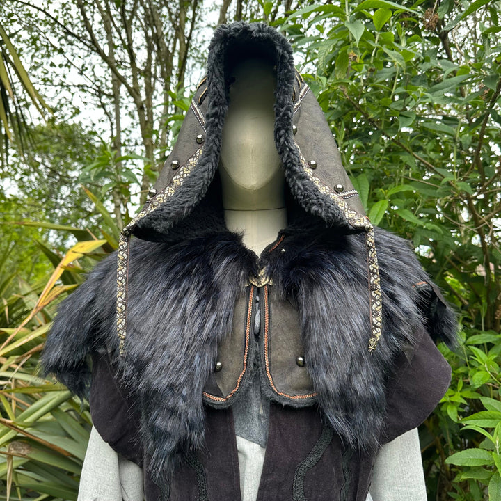 This Ornate LARP Hood in Black Faux Leather has a Faux Fur Mantle in Black & Blue. This Viking Hood is Water Resistant towards rain. The Medieval Hood covers your shoulders and provides warmth. This LARP Hood has metal Clasps, perfect for your LARP Character and LARP Costume, Cosplay Event, and Ren Faire.