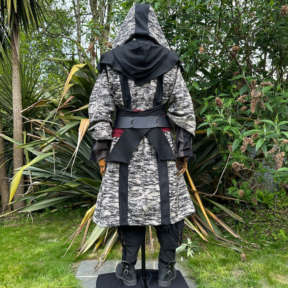 Medieval LARP costume back view, featuring brown and black hooded robe, wool hood, shirt, trousers and sash. For Renaissance Faire and historical roleplay events.