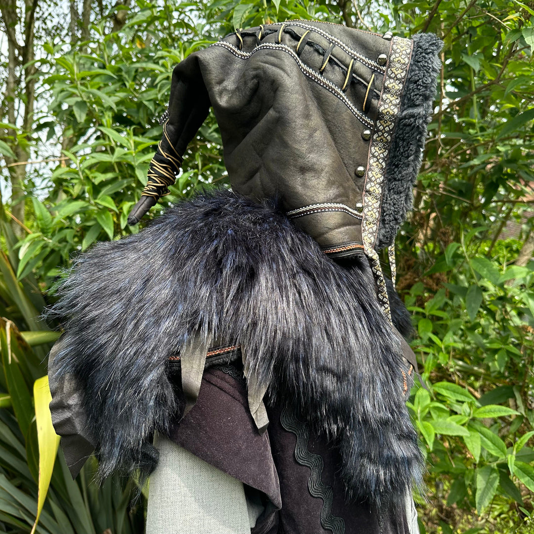 This Ornate LARP Hood in Black Faux Leather has a Faux Fur Mantle in Black & Blue. This Viking Hood is Water Resistant towards rain. The Medieval Hood covers your shoulders and provides warmth. This LARP Hood has metal Clasps, perfect for your LARP Character and LARP Costume, Cosplay Event, and Ren Faire.