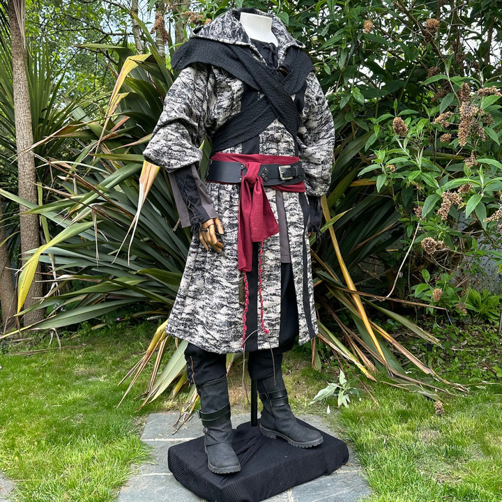 Medieval LARP costume side view, featuring brown and black hooded robe, wool hood, shirt, trousers and sash. For Renaissance Faire and historical roleplay events.