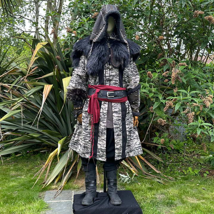 Medieval LARP costume front view, featuring faux leather hood and vambraces, brown hooded robe, shirt, trousers, belt and sash. For Renaissance Faire and historical roleplay events.