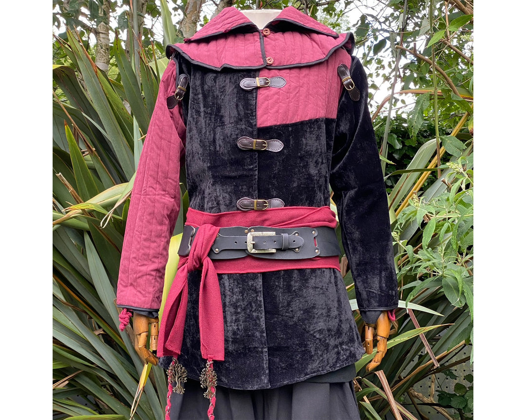Front view of a medieval LARP costume, featuring a black and red gambeson jacket, matching snood hood, and two-tone shirt. Medieval costume for Renaissance Faire and roleplay events.