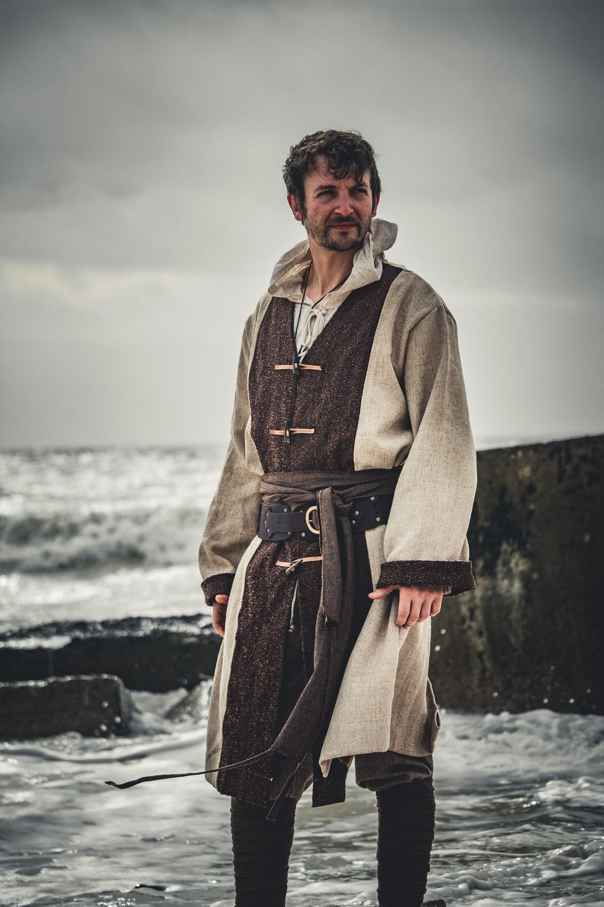 Medieval LARP shirt, natural linen and brown wool, worn at coastline.