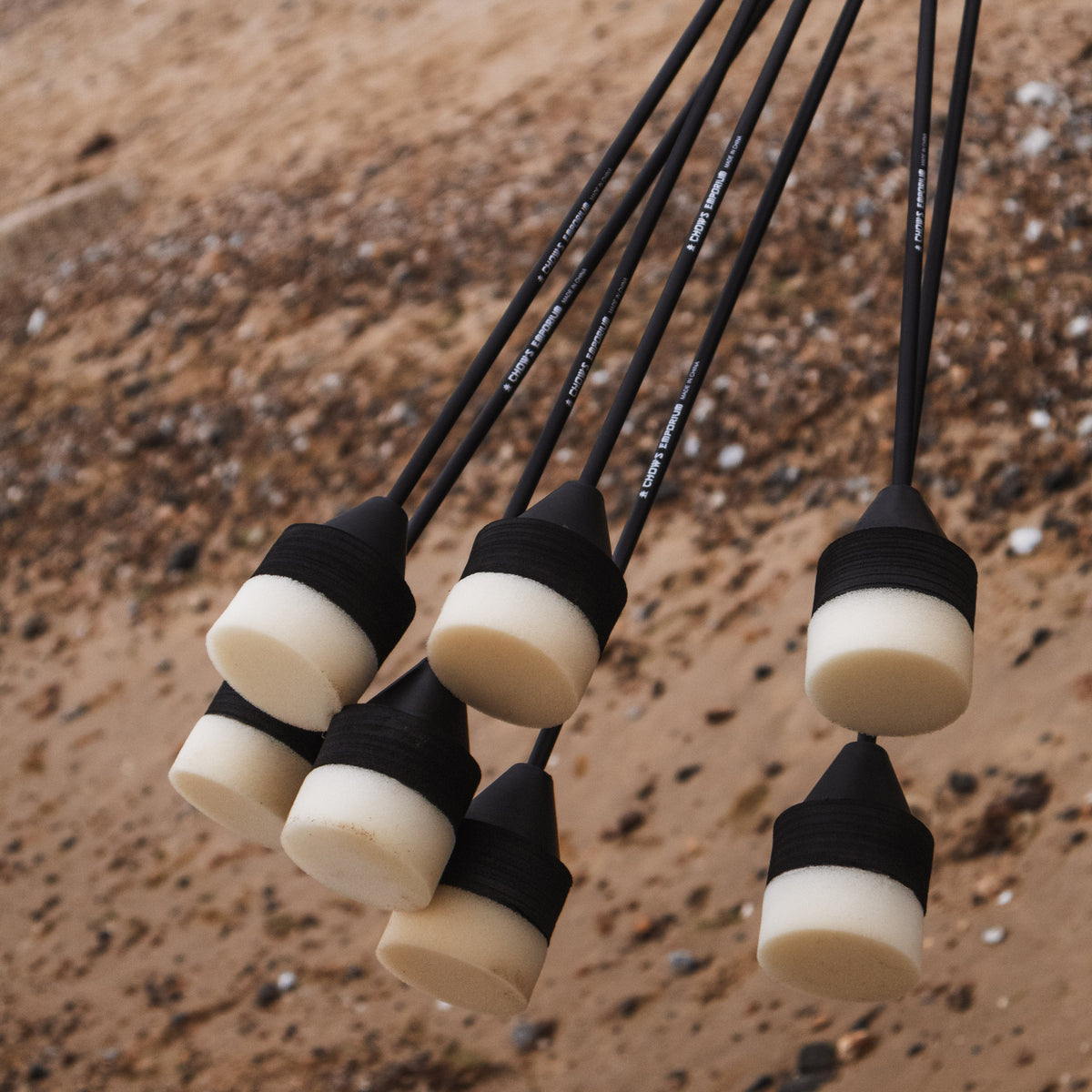 set of black and white foam headed arrows for larp and cosplay being held on the beach.
