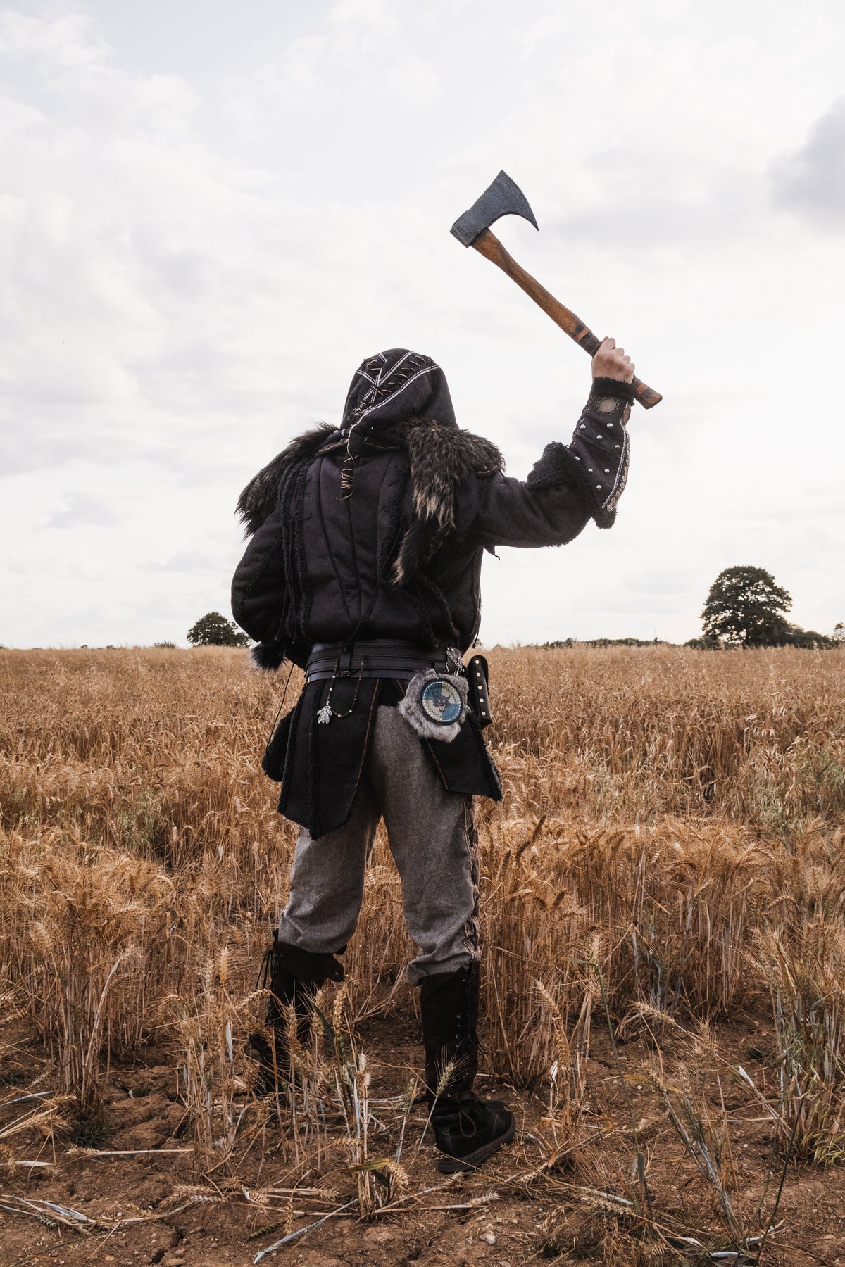 Dark warrior set with black fur-trimmed jacket and hood, medieval LARP style.