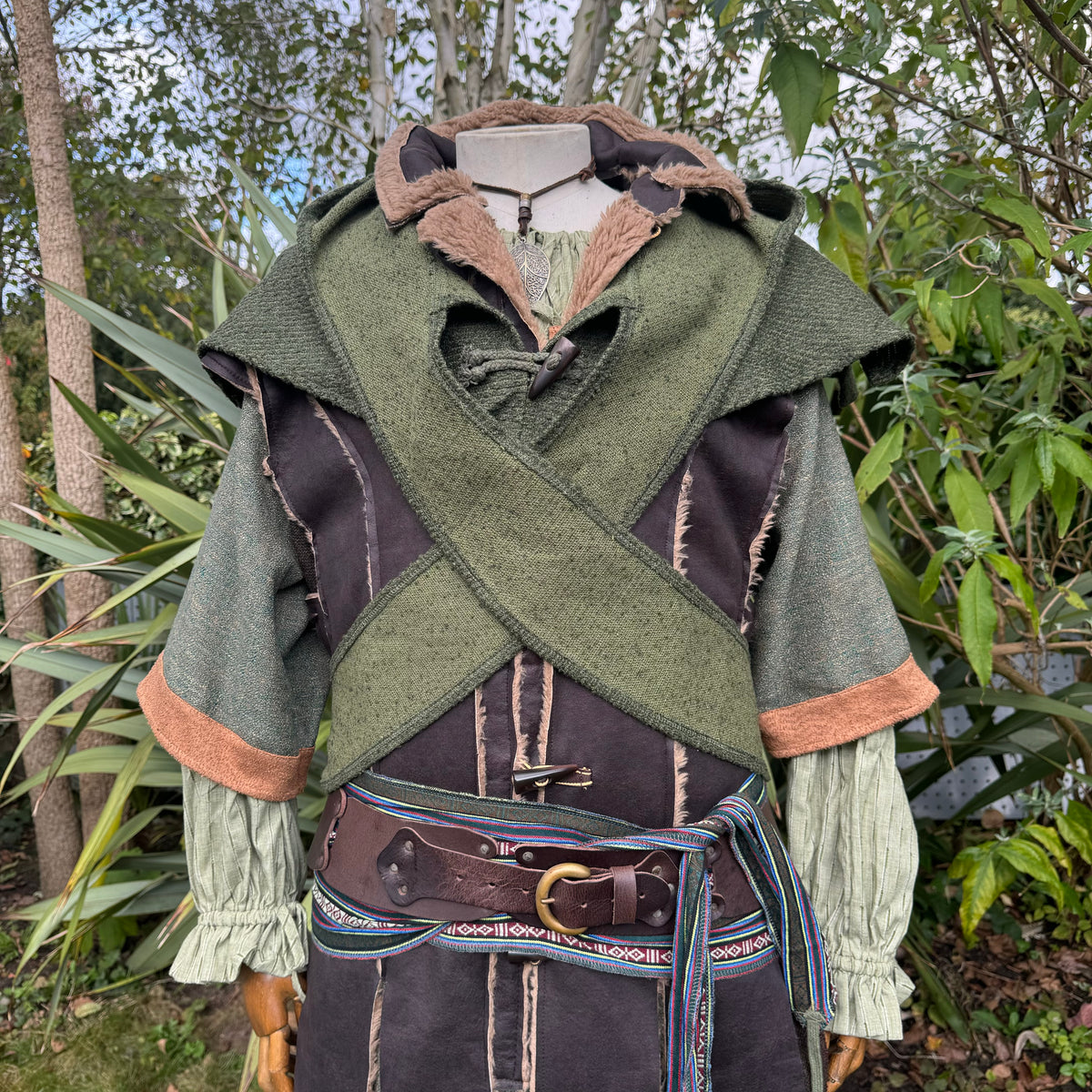 Green wool scarf hood on a medieval costume with leather belt detailing.