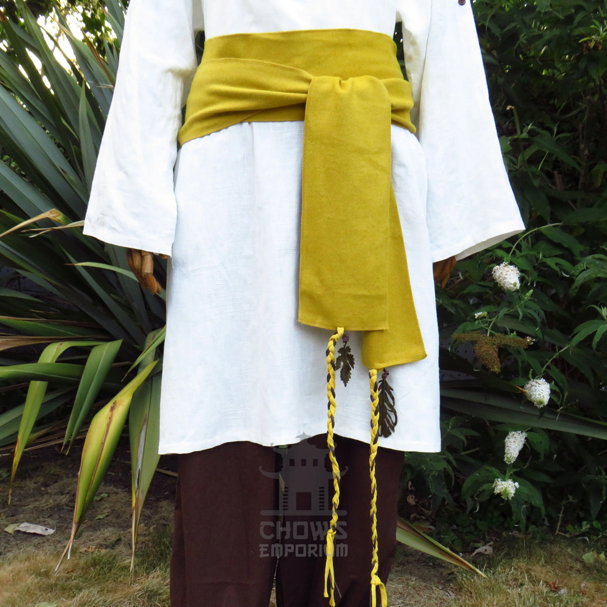Ochre wool sash worn round the waist over a white shirt, ends hanging