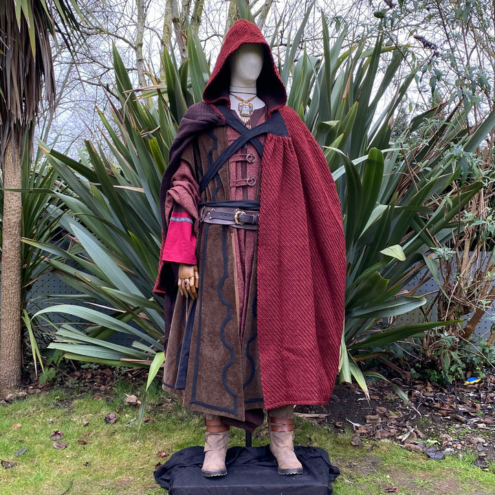 The Four Way LARP Cloak in Red Herringbone Wool with Reversable Grey Faux Fur & Leather Brown Mantle is a Versatile Cape with Hood. The Medieval Cloak is Water Resistant and helps keep you warm. The Viking Style Cloak can be worn in four ways; perfect for your LARP character, Cosplay Events, and Ren Faires. 