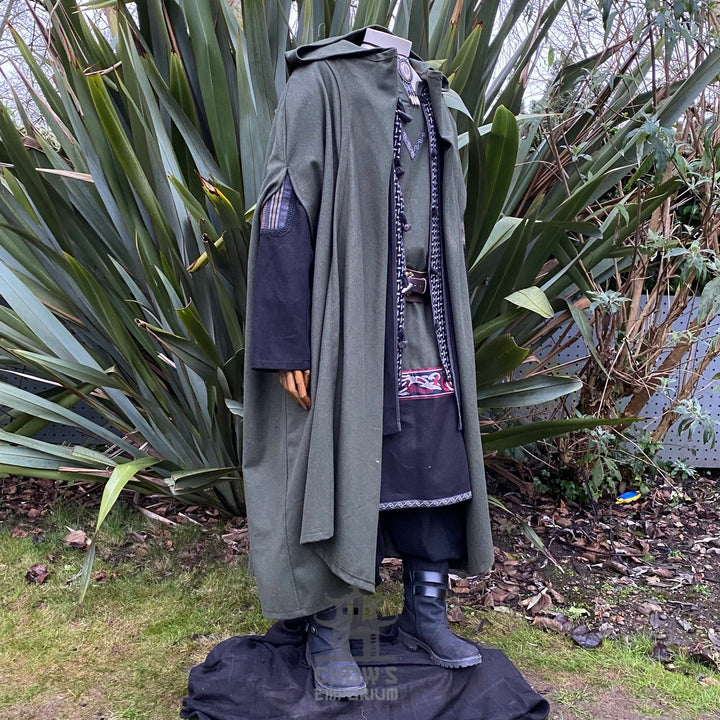 Medieval LARP outfit side view, featuring a green hooded cloak, jacket, tunic, trousers, belt and sash. For Renaissance Faire and historical roleplay events.