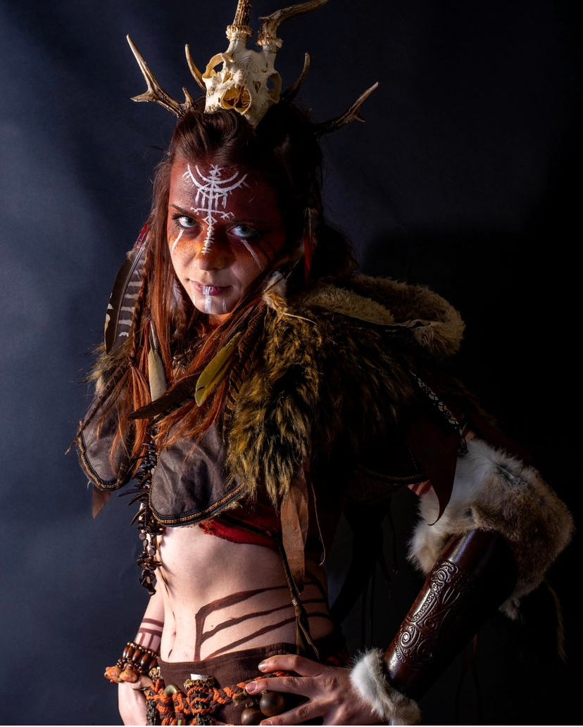 Brown ornate faux leather LARP hood, side view, with fur trim and details.