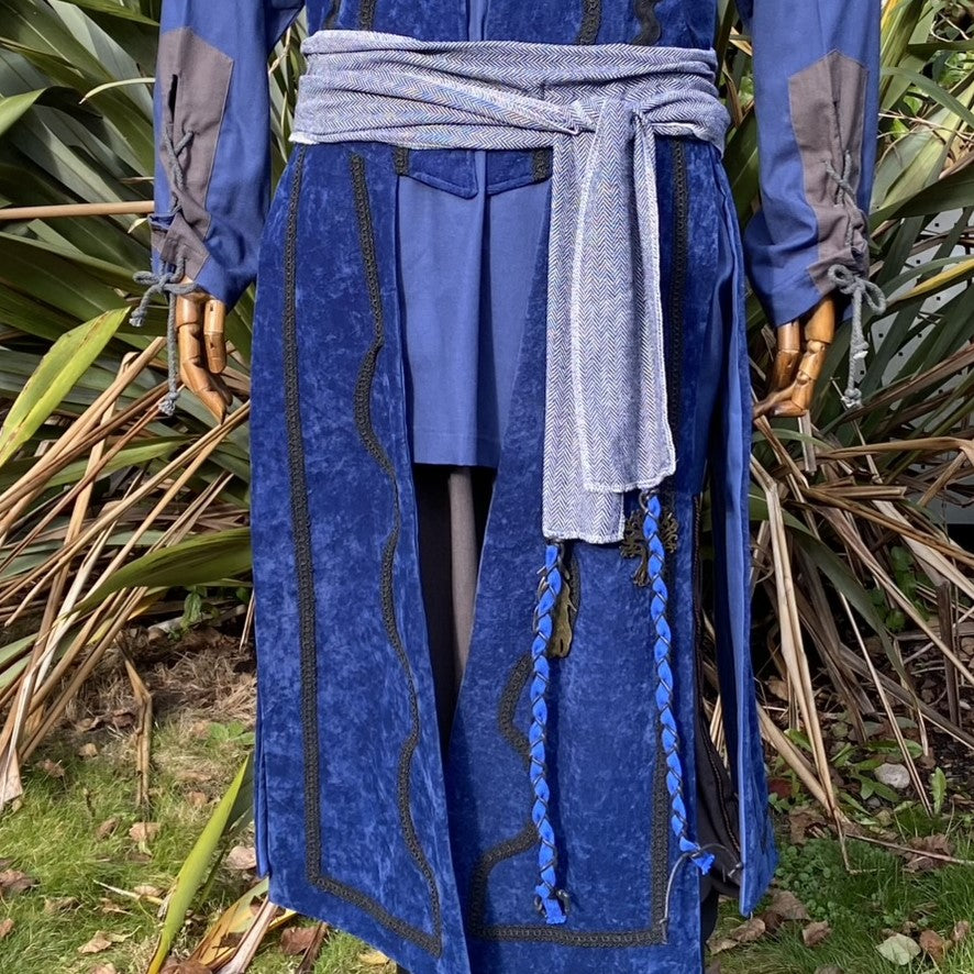 Close-up of blue suede-effect fabric showing textured finish and ornate stitching on fantasy.