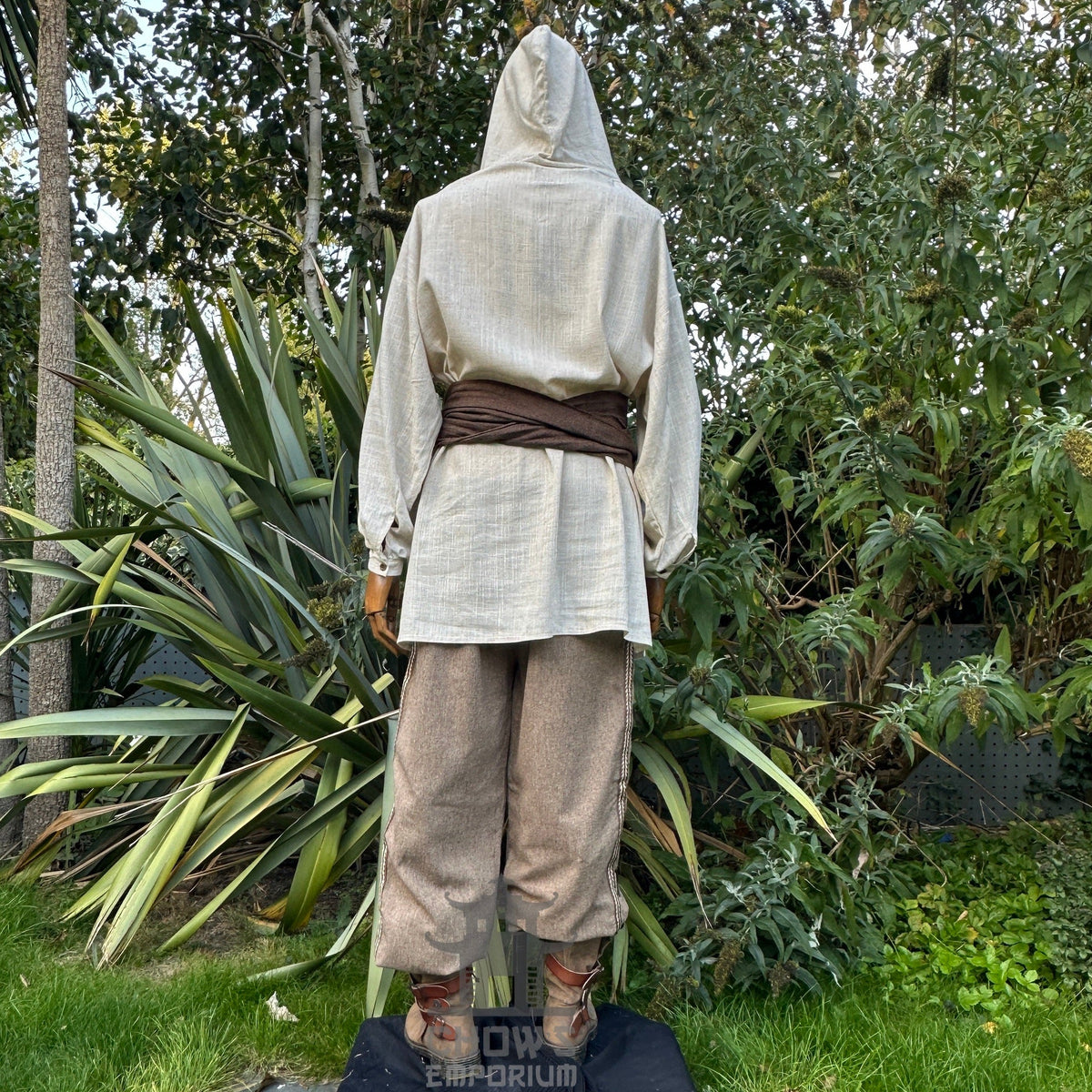 Natural LARP medieval outfit: hooded shirt, pants, sash, rear view.