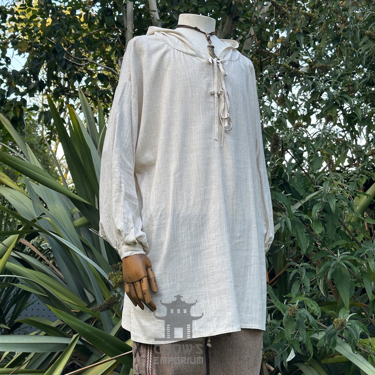 Natural beige hooded shirt for LARP with wooden mannequin arm.
