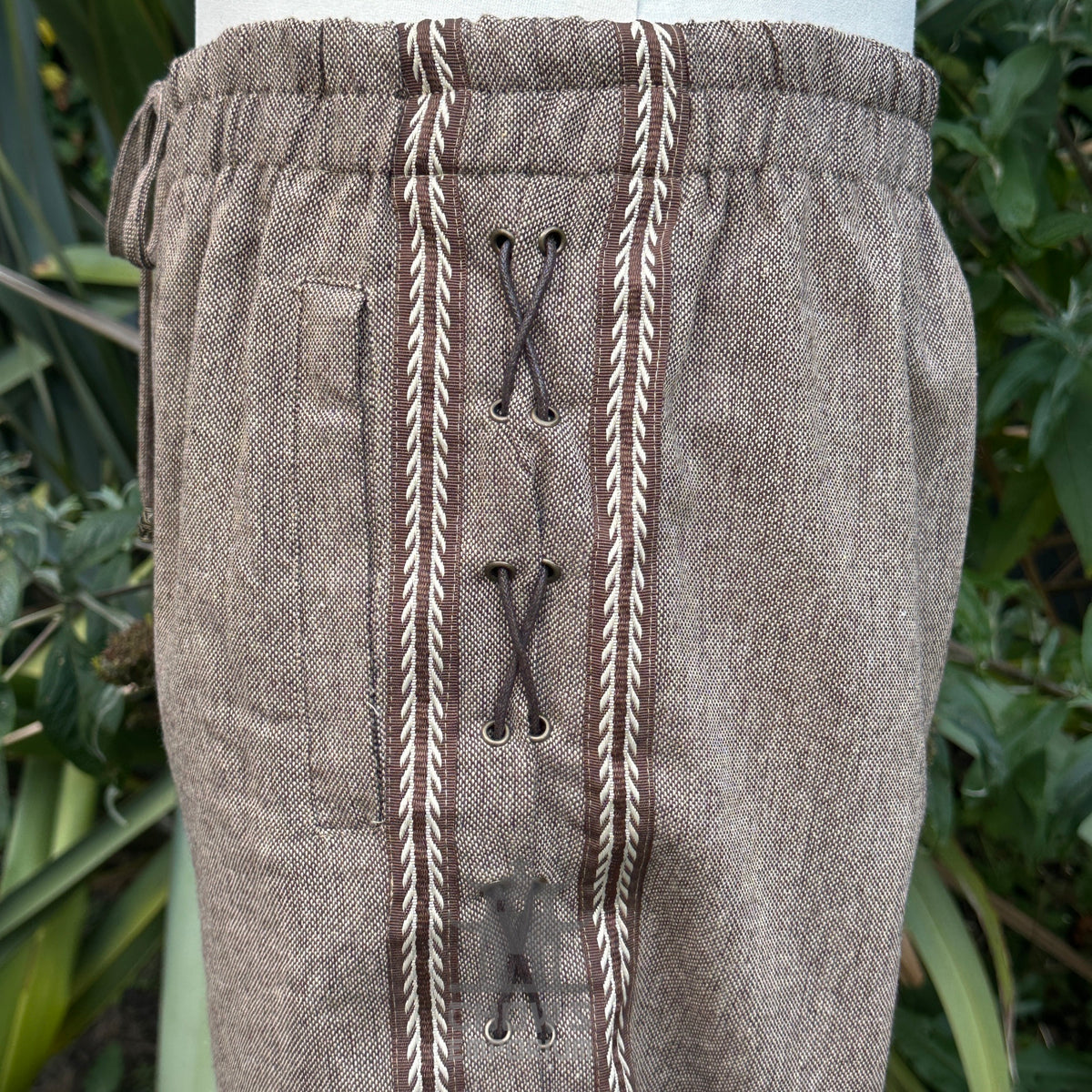 woolen medieval pants with side braiding for fantasy costume close up.