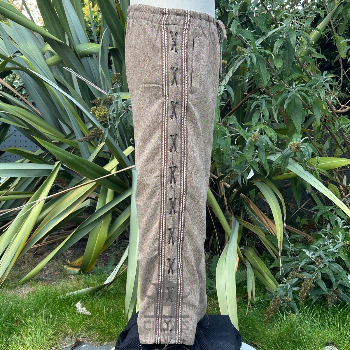 straight-leg brown wool trousers with side lace and braiding trim.
