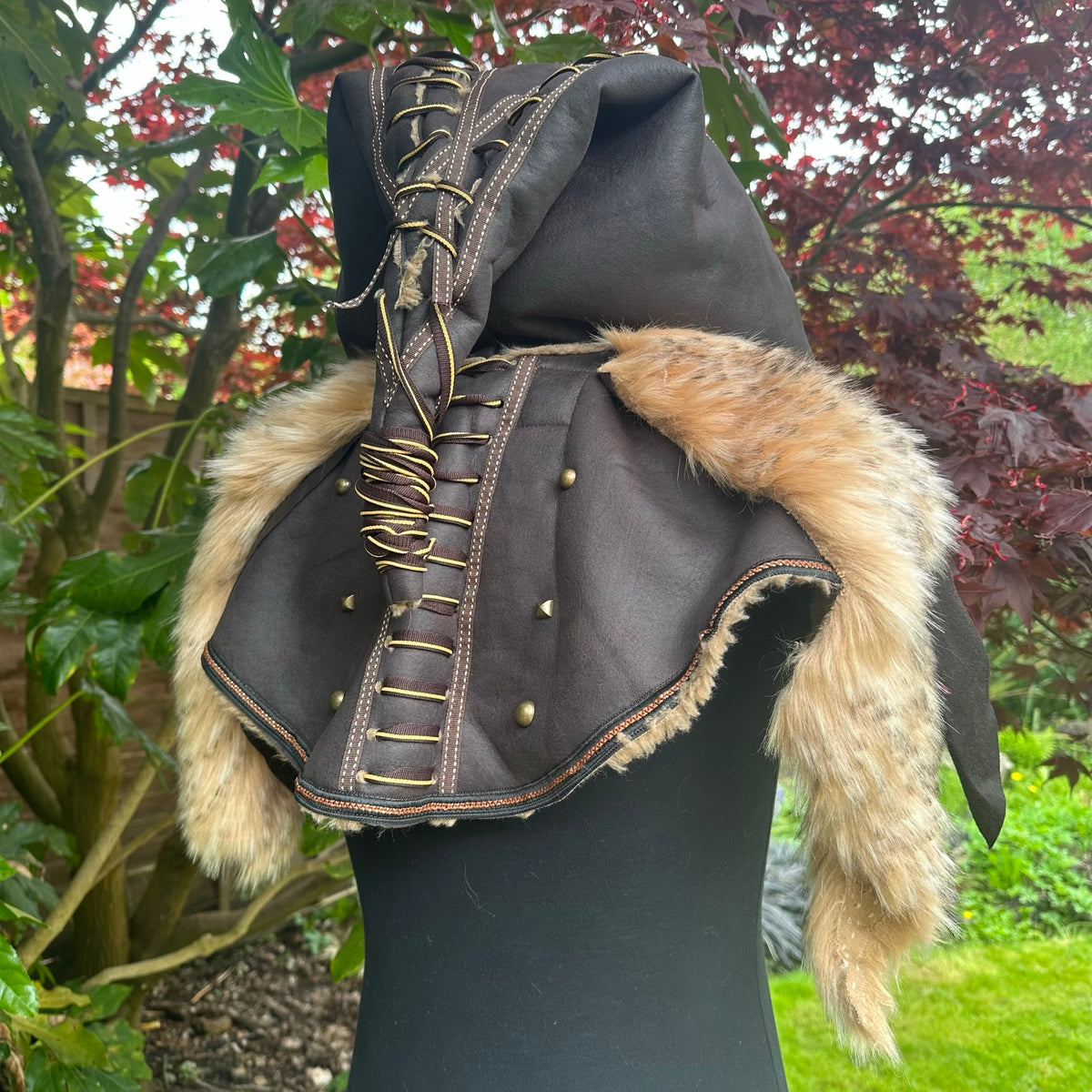 LARP barbarian hood with fur trim, laced detailing, side view.
