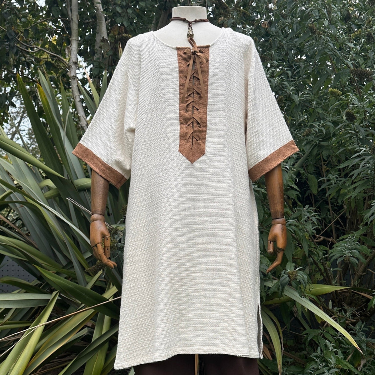 White and brown woven medieval tunic for LARP on mannequin front view.