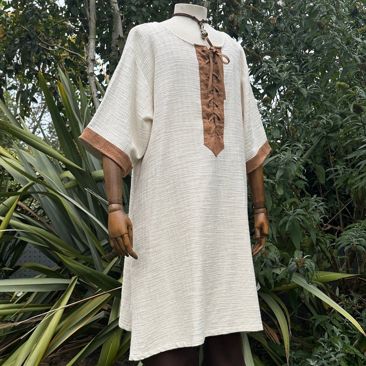 White and brown woven medieval tunic for LARP, front view with brown accents.