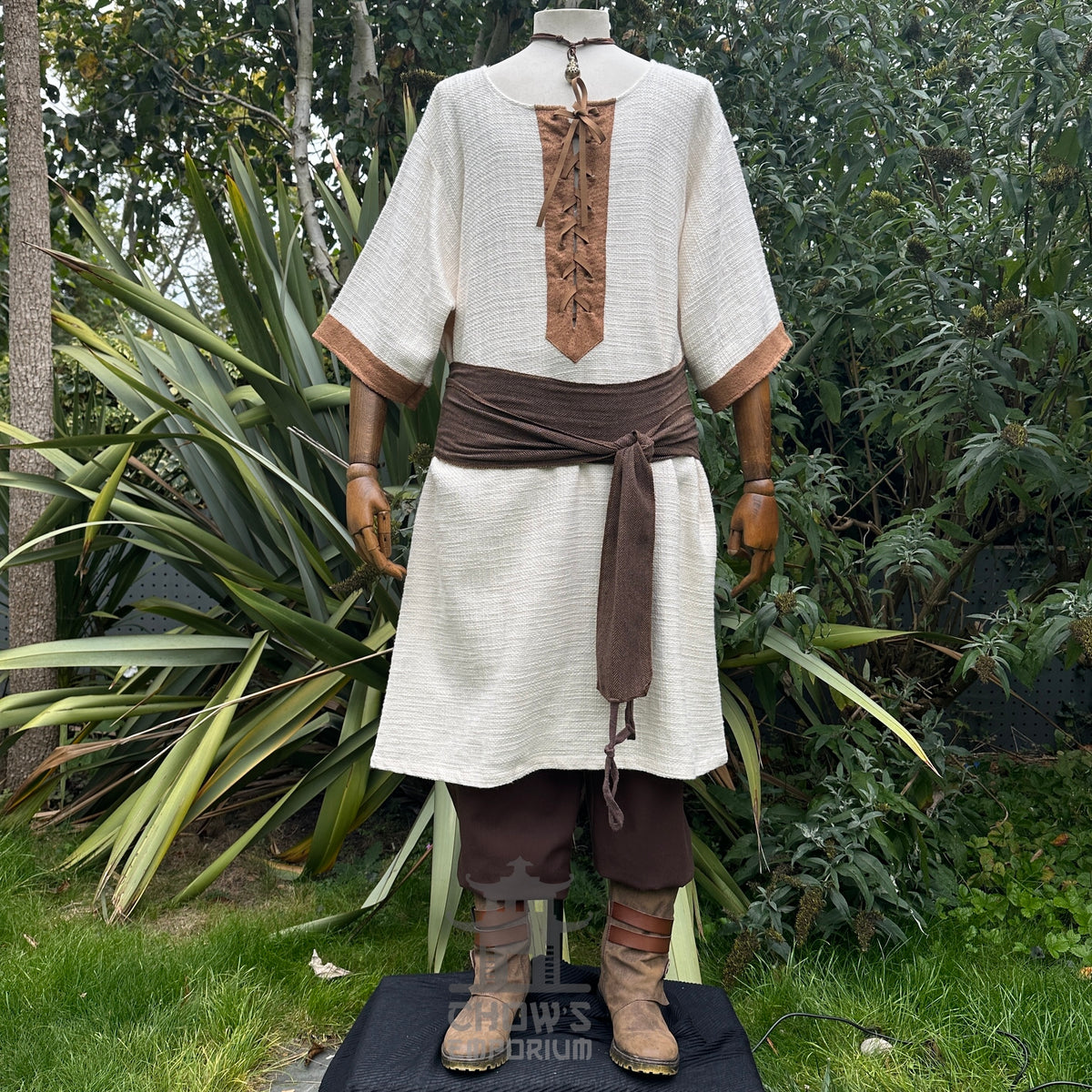 Medieval LARP outfit front view, featuring a white and brown shirt, trousers, and sash.