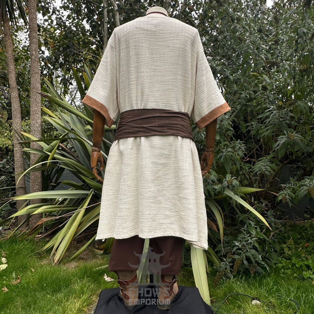 Medieval LARP outfit back view, featuring a white and brown shirt, trousers, and sash. For Renaissance Faire and historical roleplay events.