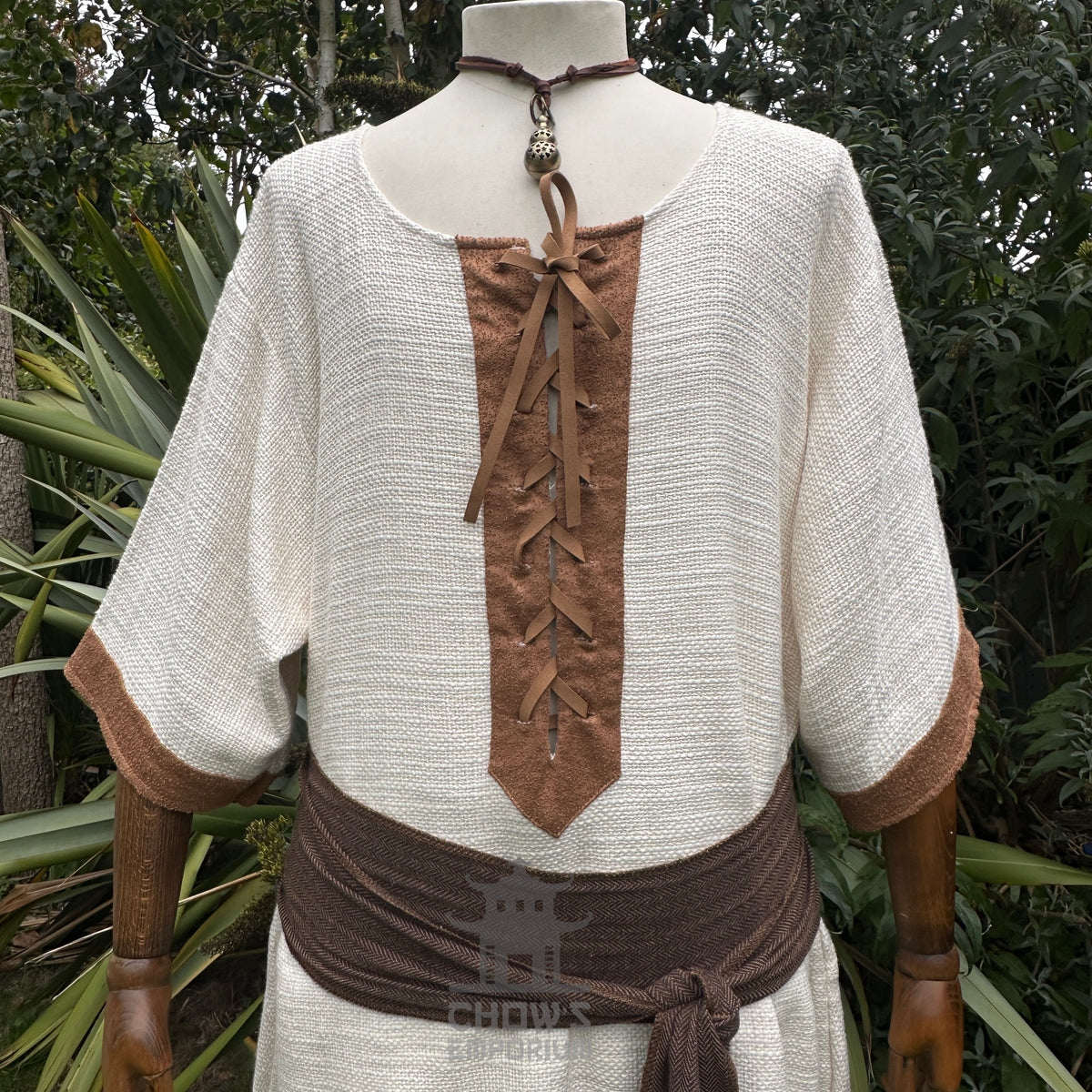 White and brown woven medieval tunic, front view.