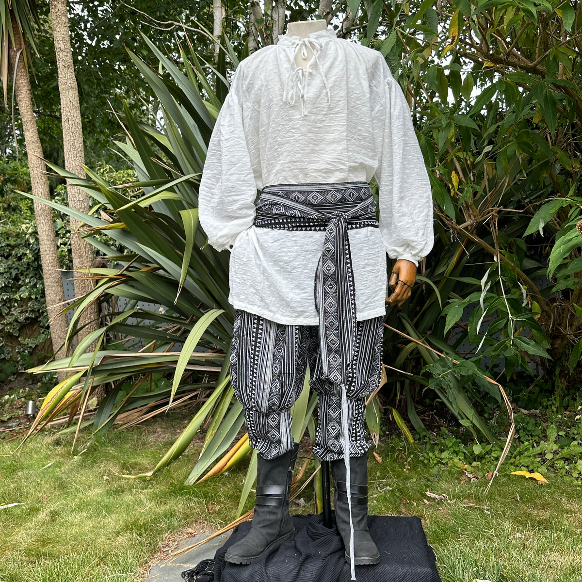Medieval LARP outfit front view, featuring a white shirt, black and white trousers and matching.