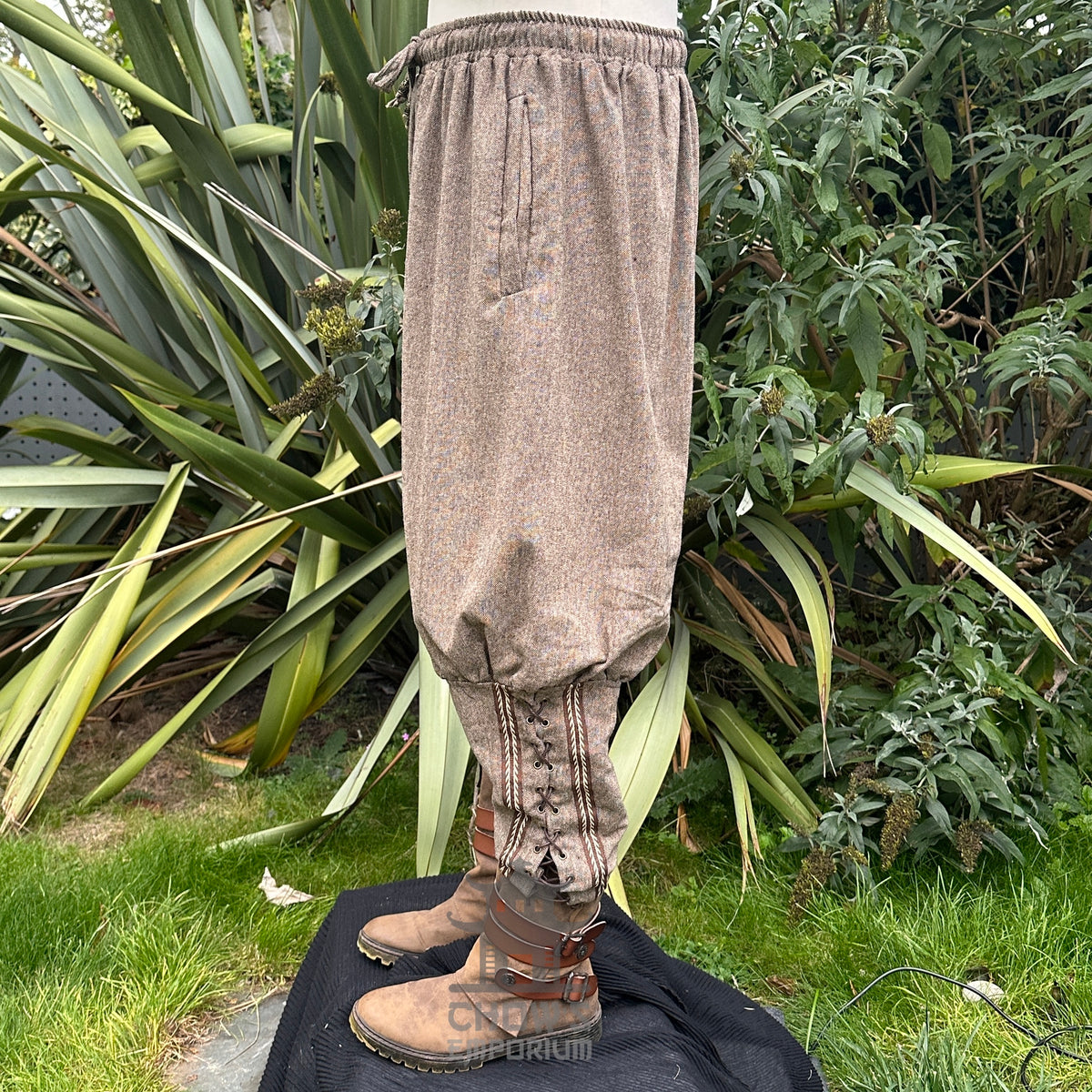 wool Viking trousers with decorative braiding detail.