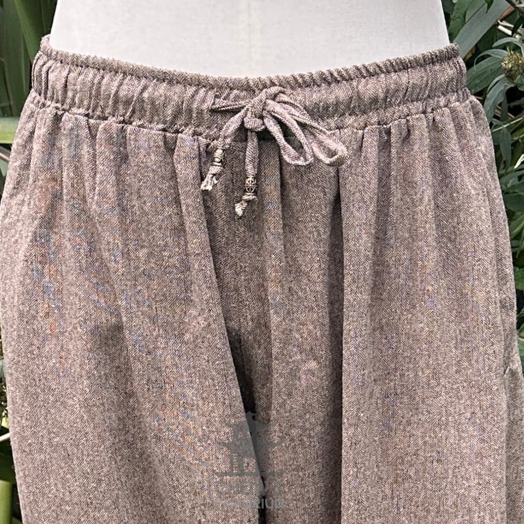 close up of drawstring detail on brown wool pants