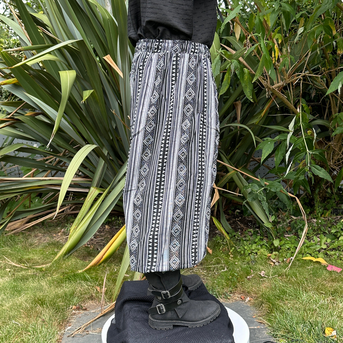 Black hooded shirt, patterned black and white pants, side view, LARP outfit.
