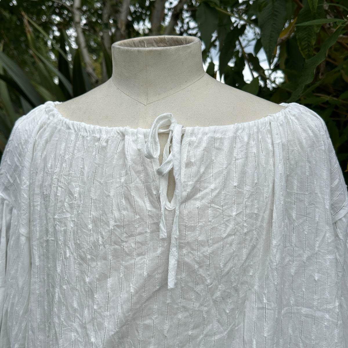 White cotton medieval shirt with round neck, front view, suitable for LARP.