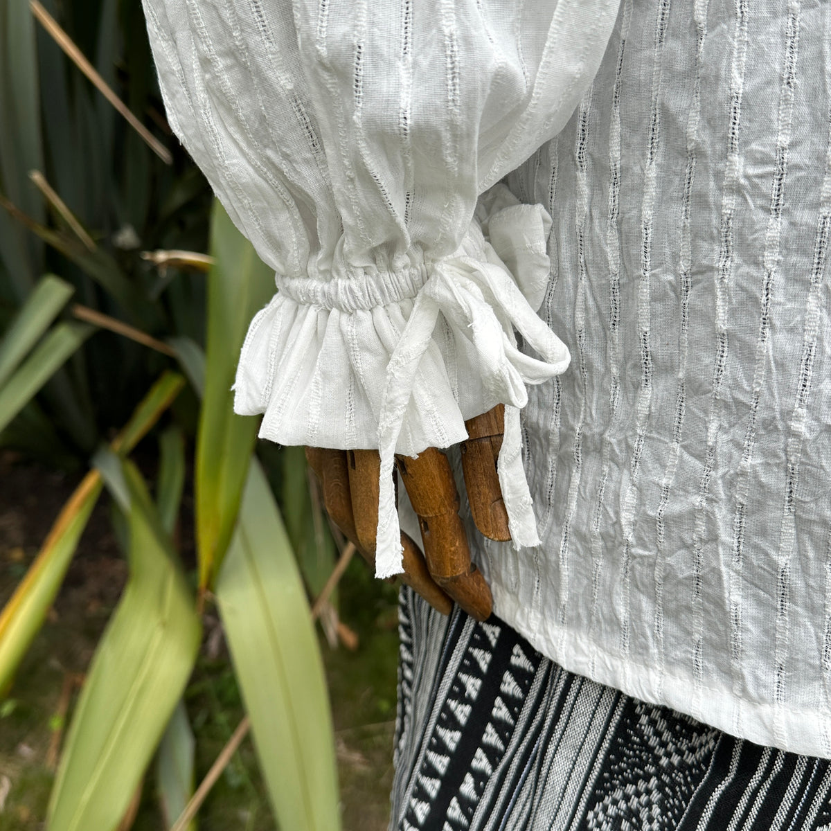 White cotton medieval LARP shirt with round neck and gathered sleeves.