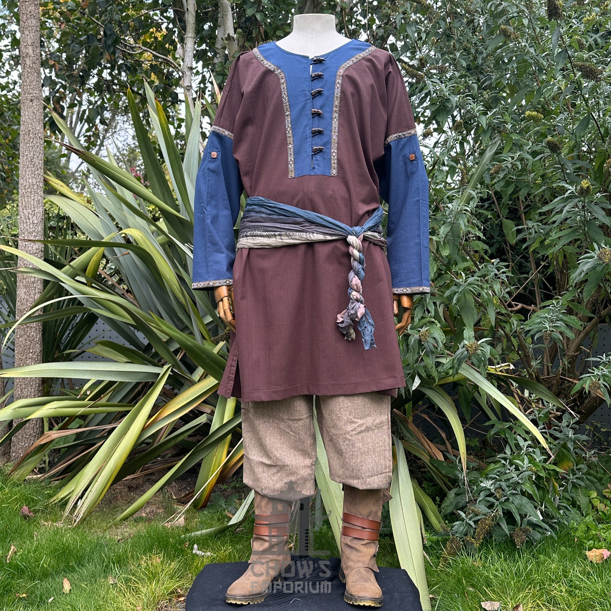 Brown and blue LARP tunic, trousers, and sash on mannequin.