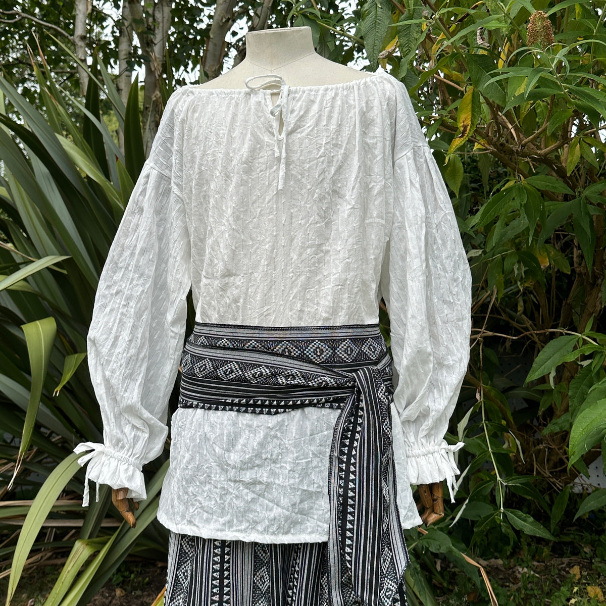 Black and white pirate sash on mannequin, tied around waist, LARP attire.