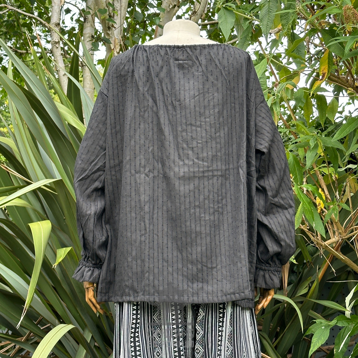 Black striped LARP shirt viewed from the back, long sleeves.