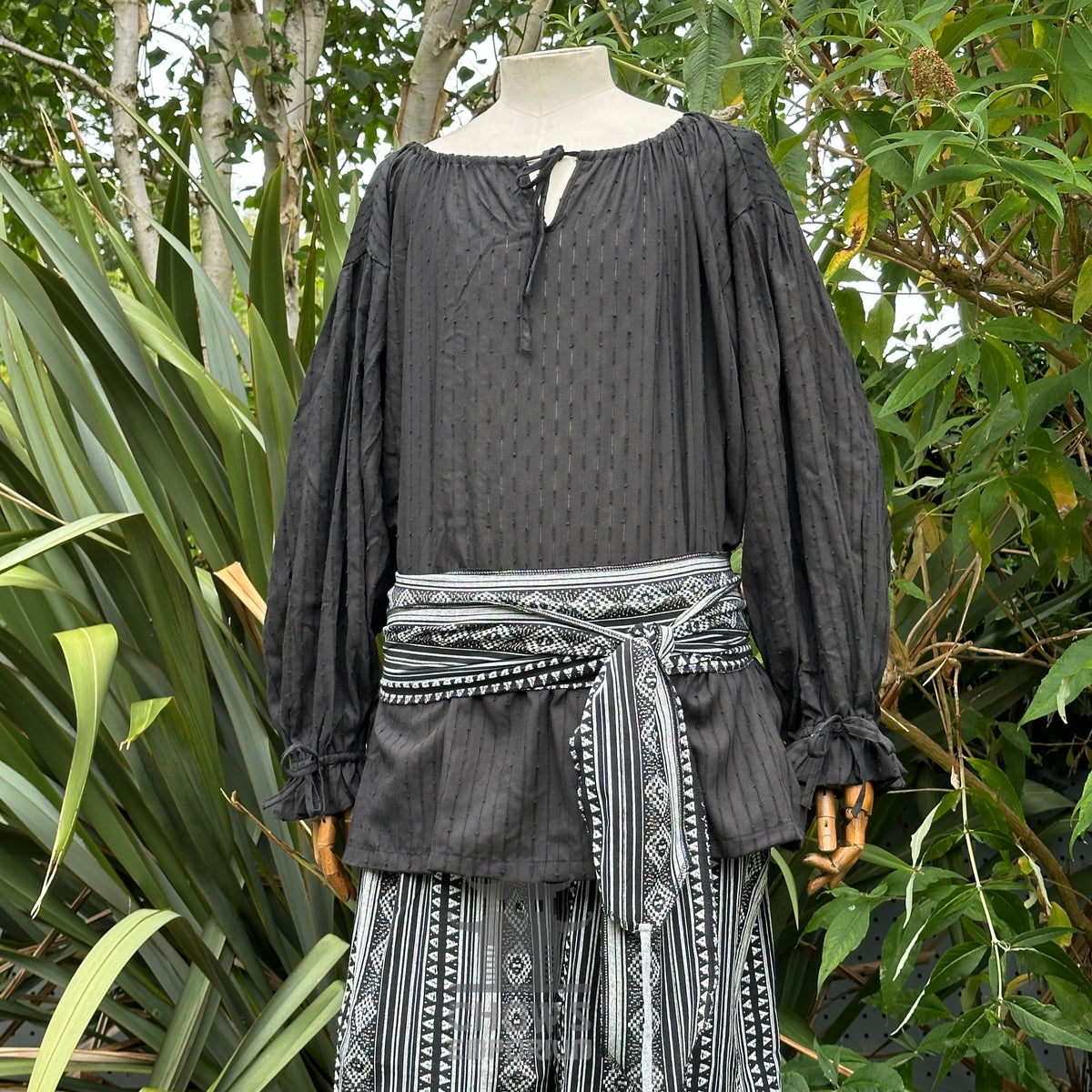 Black long-sleeve shirt with patterned sash and pants, LARP medieval style.