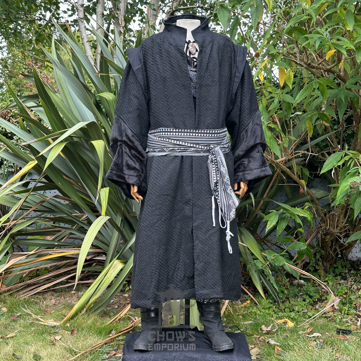 Medieval black LARP warlock outfit with robe, patterned sash, and cape.