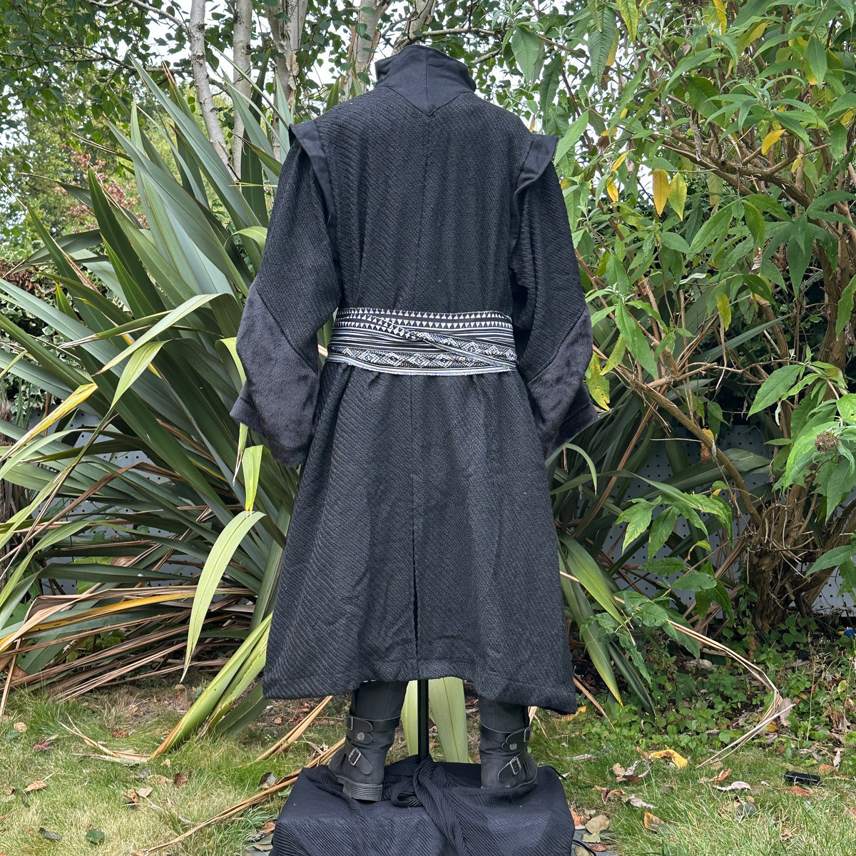 Back of black wool LARP robe with patterned belt.